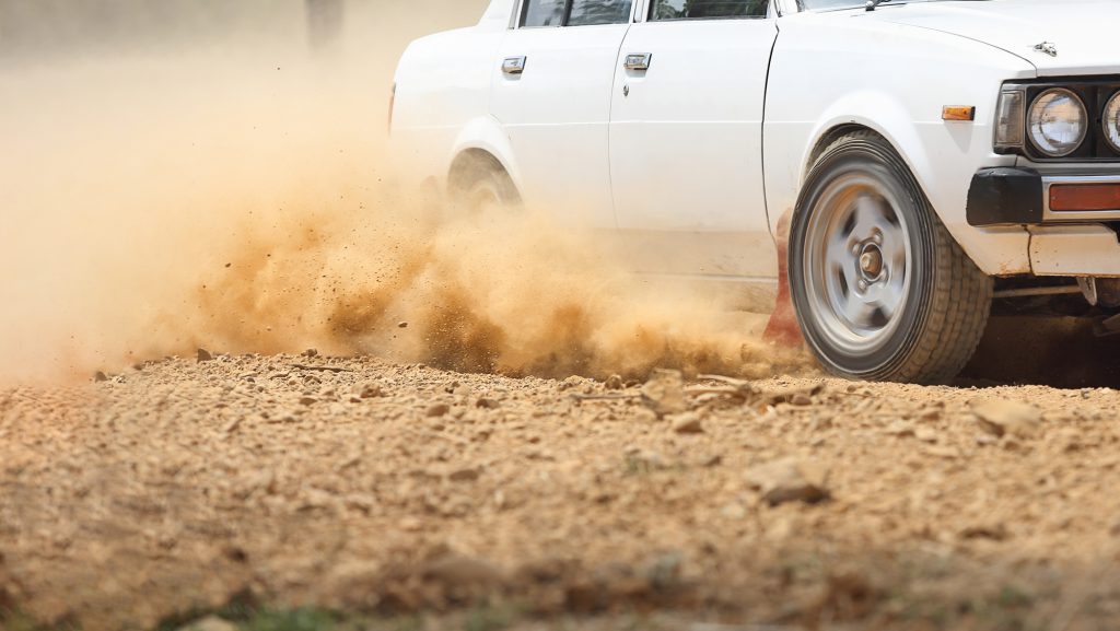 Retro Rally Car turning in dirt track